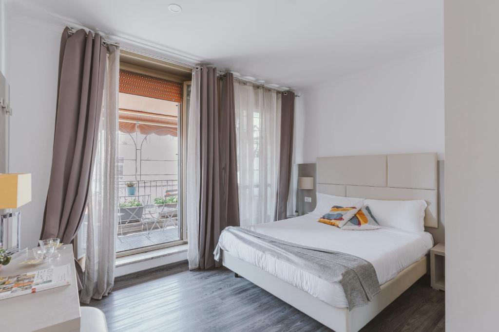 a bedroom with a bed and a large window at Residenza Il Giglio in Rome