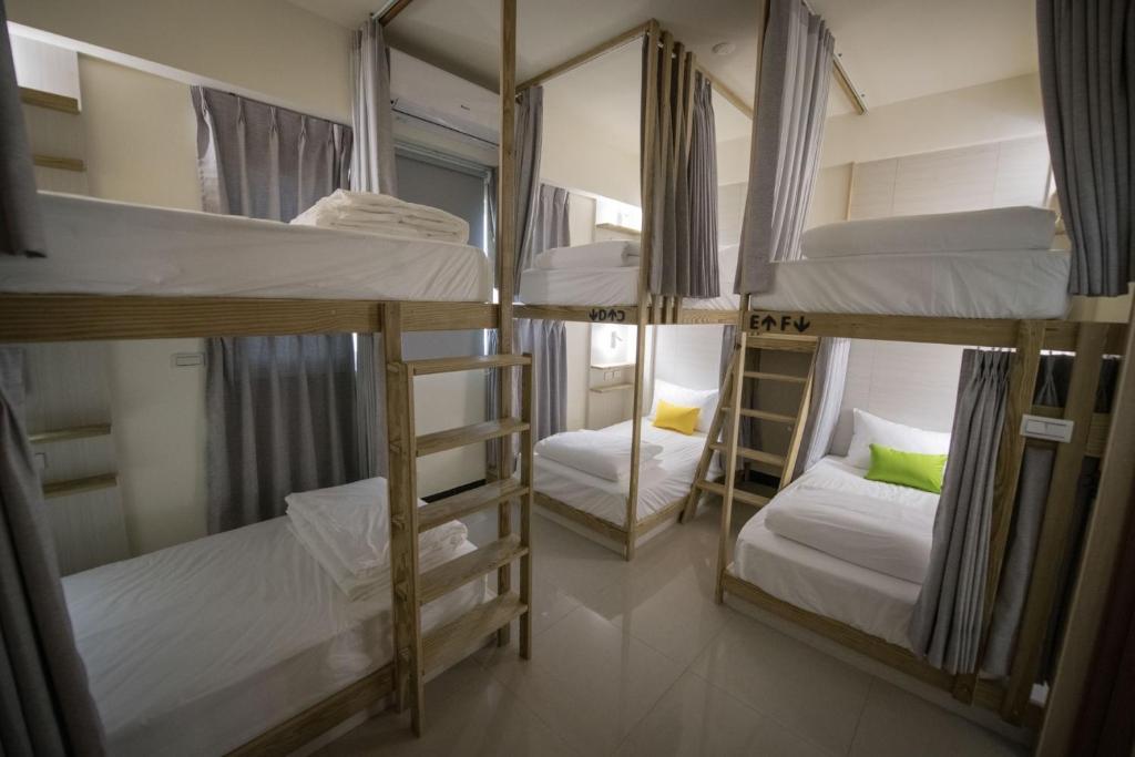 Postel nebo postele na pokoji v ubytování 漫時光 旅空間 ManLu INN
