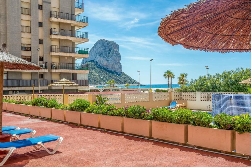 a resort with a view of the ocean and a mountain at Apartamentos Amatista Unitursa in Calpe