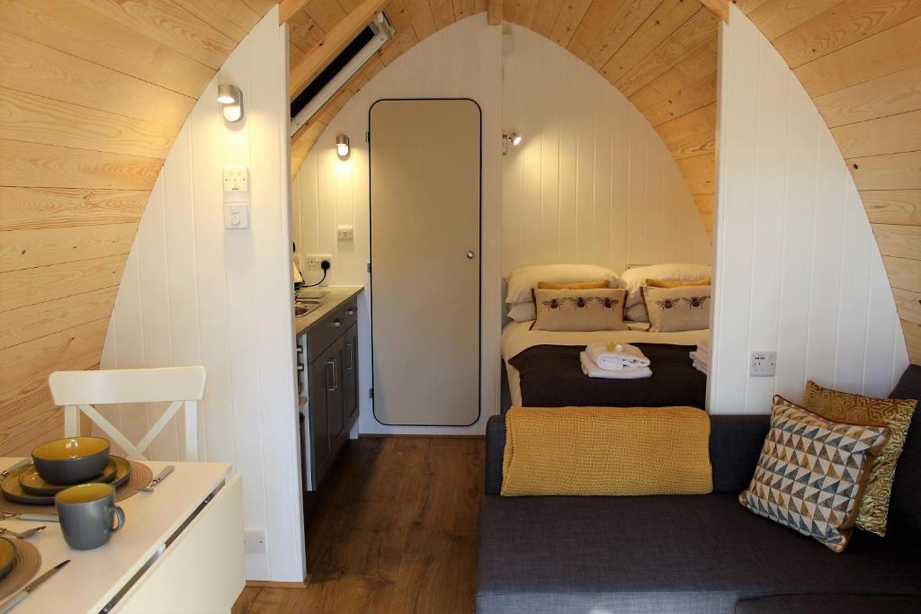 a room with two beds in a small room at The Honeybee Pod in Penrith