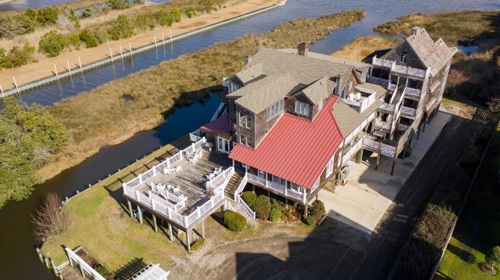 an aerial view of a house on the water at The Burrus House Inn Waterfront Suites in Manteo