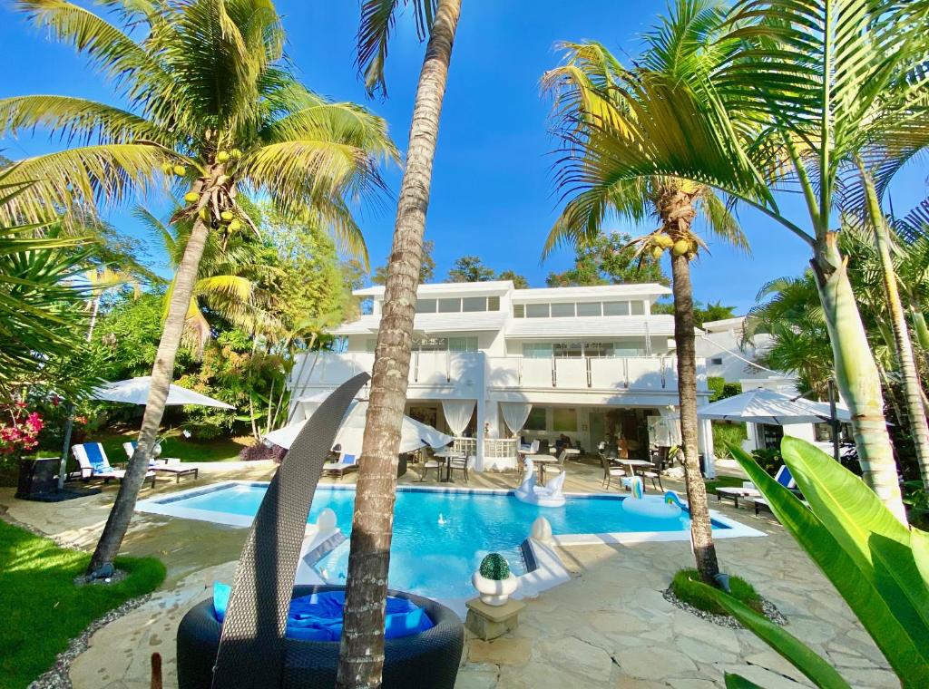 een uitzicht op een resort met palmbomen en een zwembad bij Casa Veintiuno in Sosúa