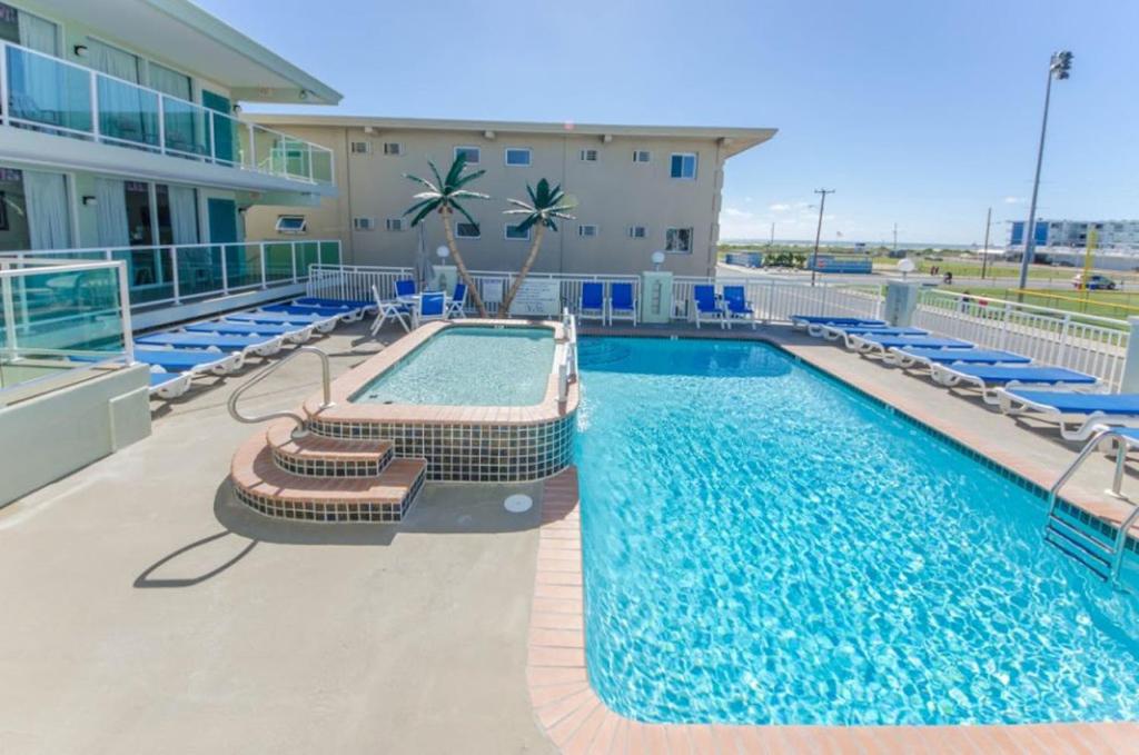 una piscina con tumbonas y un complejo en Crystal Beach Motor Inn, en Wildwood Crest