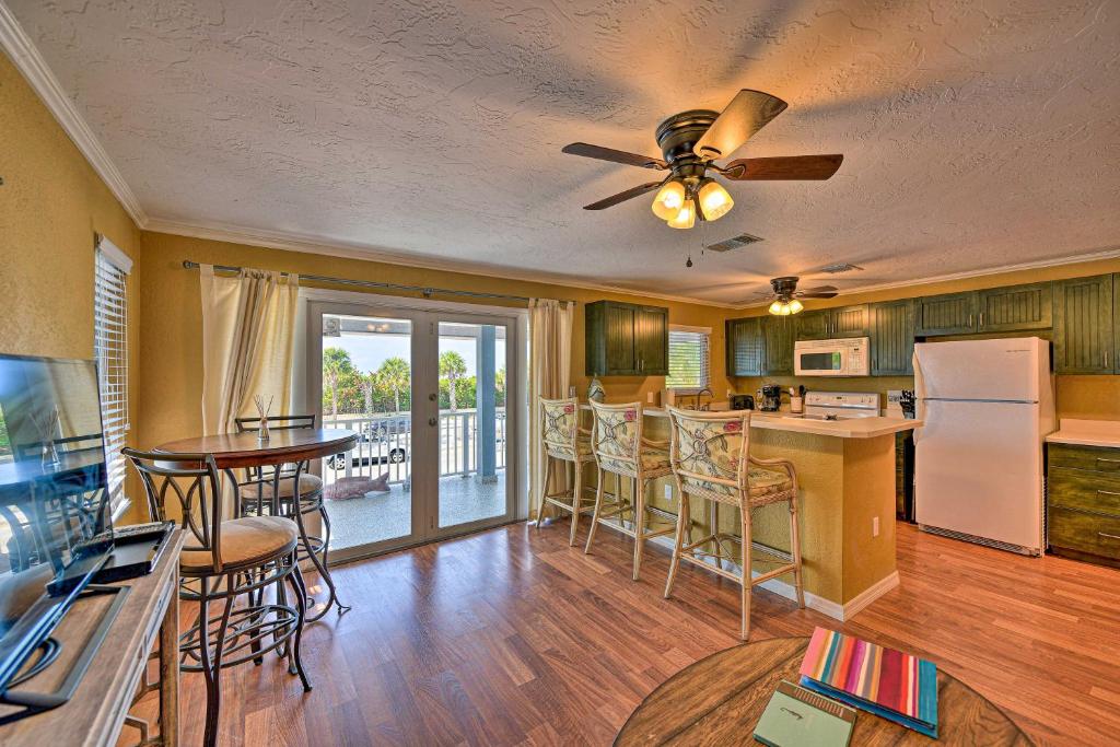 a kitchen and living room with a table and chairs at Gulfview Lido Key Gem - Walk to Beach and Shops in Sarasota