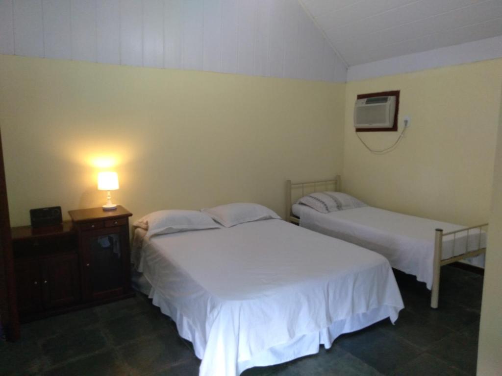 Ένα ή περισσότερα κρεβάτια σε δωμάτιο στο Casa de praia cantinho do Saco 12 pessoas