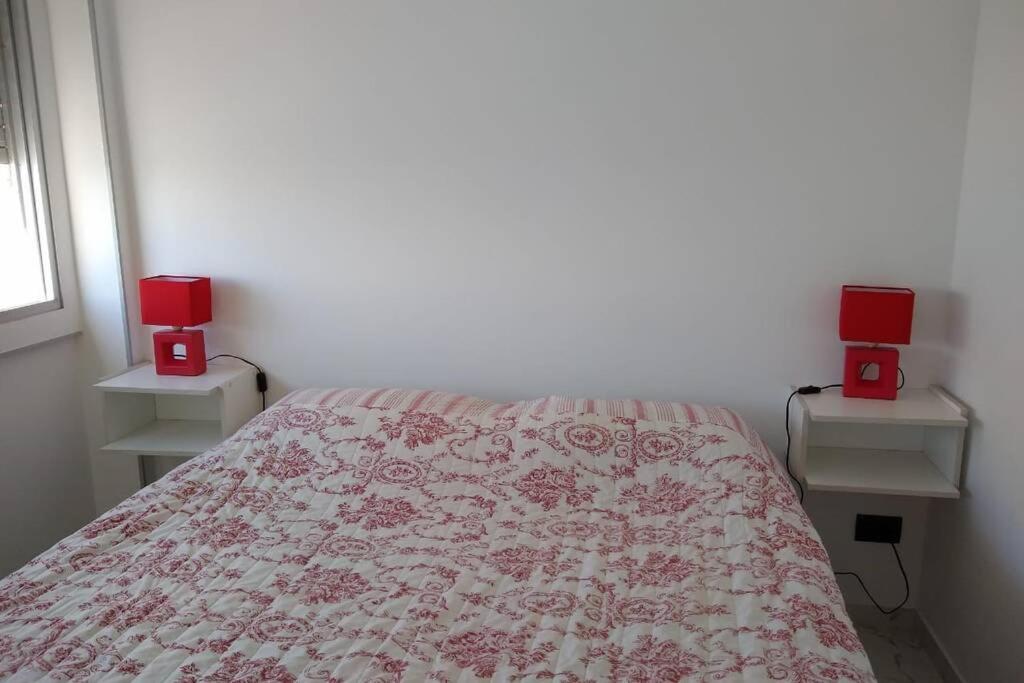 a bedroom with a bed with two red candles on it at Cabo Corrientes - Mar del Plata - Preguntar antes de reservar in Mar del Plata