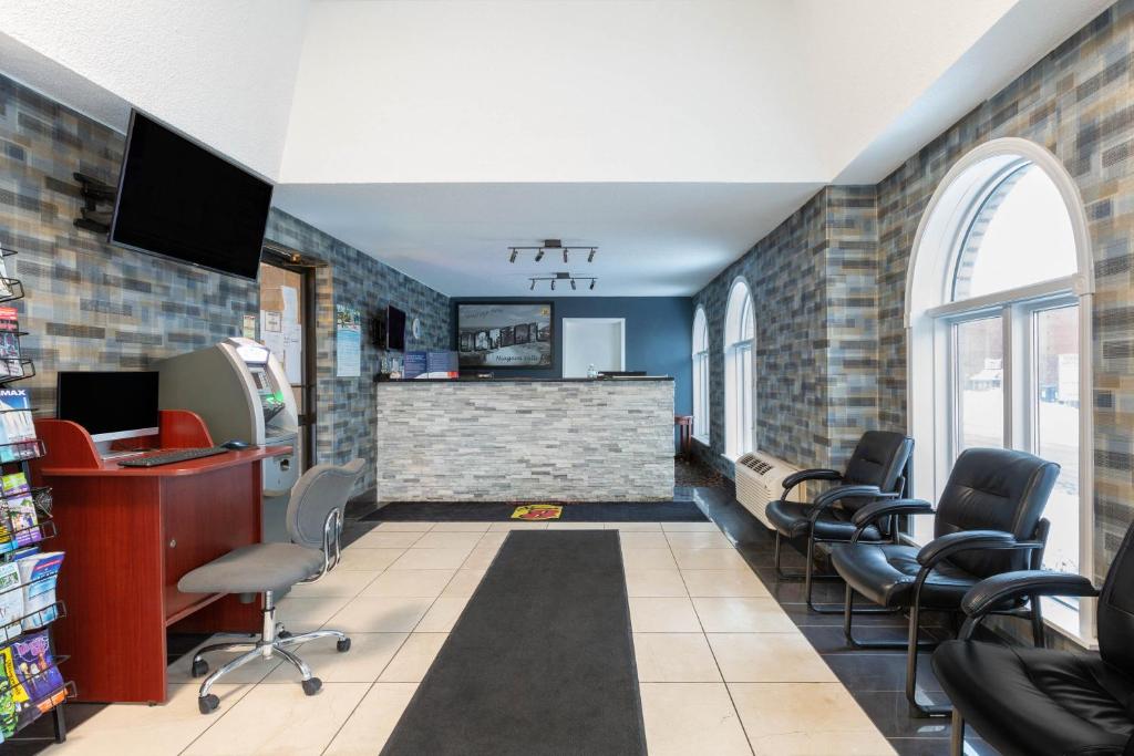 a waiting room at a hair salon with chairs at Super 8 by Wyndham Niagara Falls by the Falls in Niagara Falls