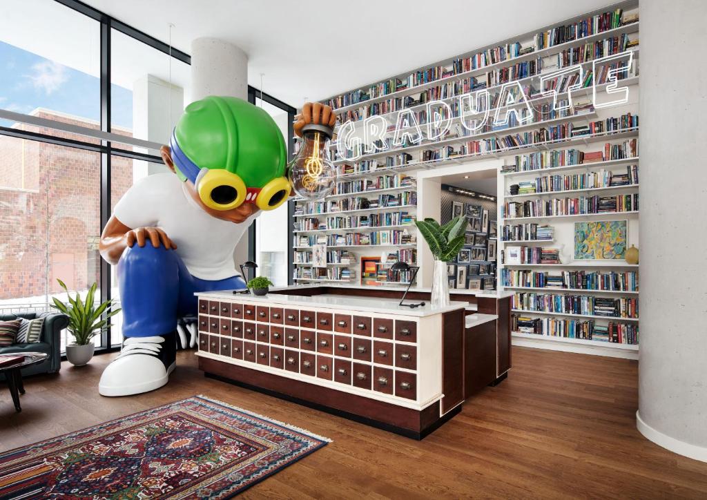 a room with a large statue of a mascot in a library at Graduate New York in New York