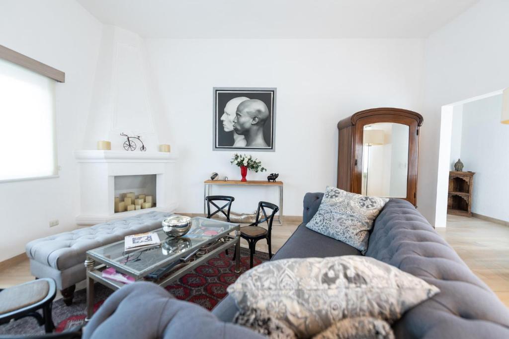 a living room with a couch and a table at Casa De La O in San Miguel de Allende