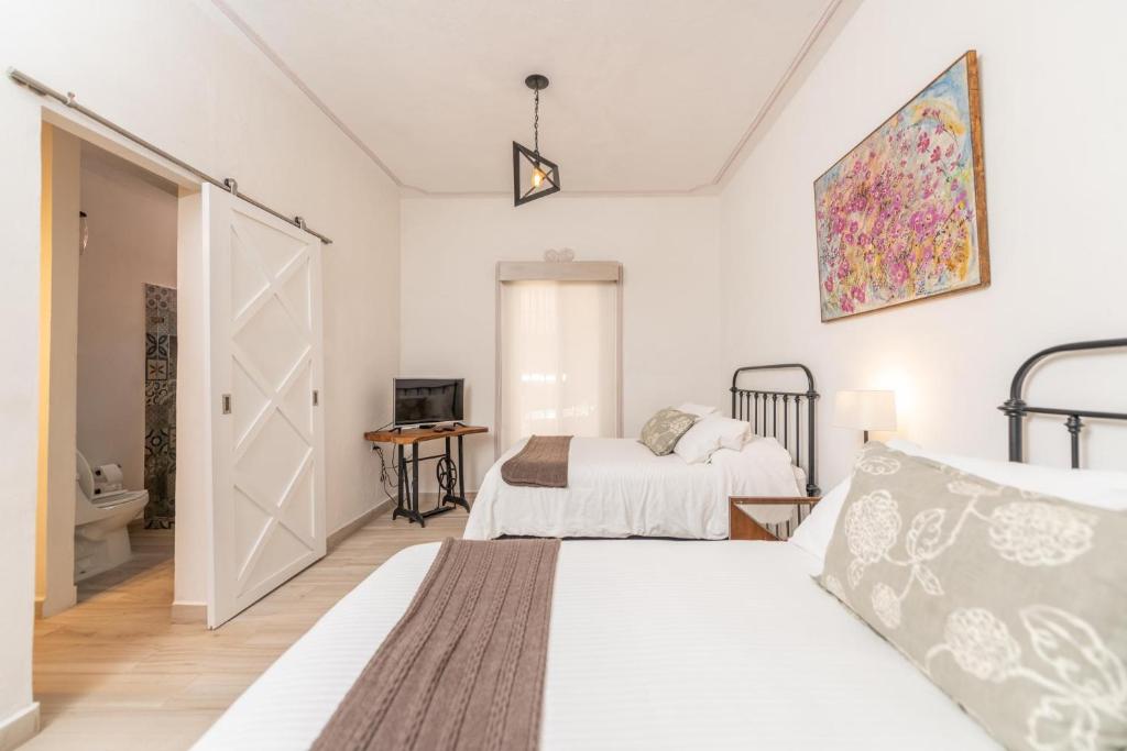 Postel nebo postele na pokoji v ubytování Casa De La O
