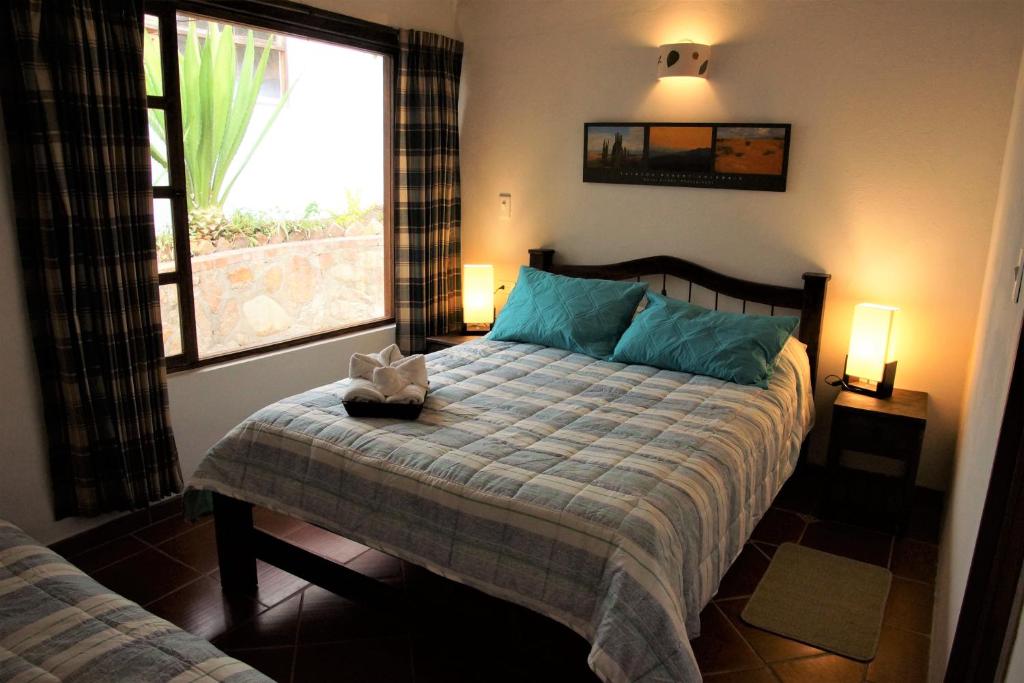 Postel nebo postele na pokoji v ubytování Hostal Renacer
