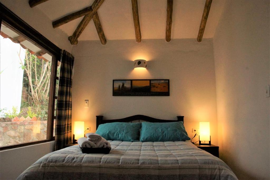 Postel nebo postele na pokoji v ubytování Hostal Renacer