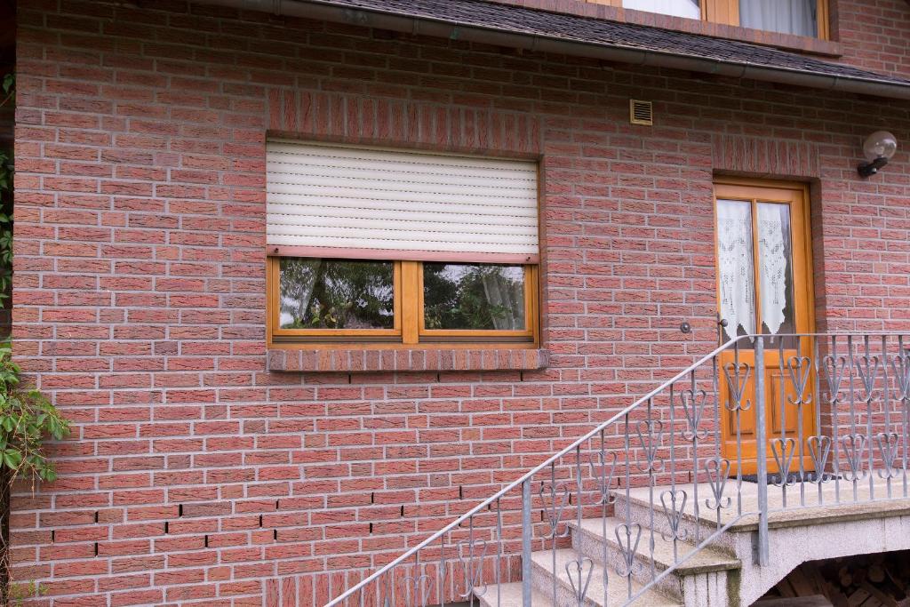 a brick building with a window and a staircase at Ferienwohnung Meinersen in Meinersen