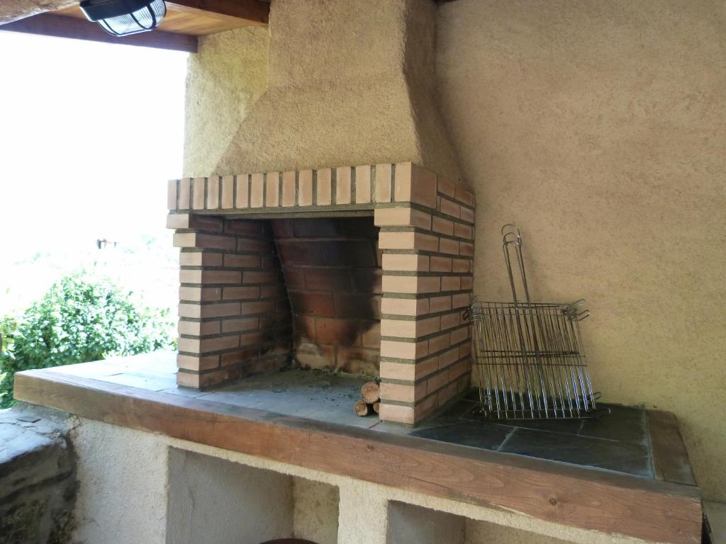 a brick fireplace on the side of a house at Casas del Parador - Las Eras in Villanueva del Conde