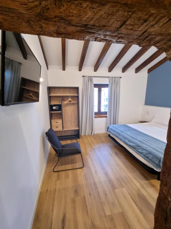 Postel nebo postele na pokoji v ubytování Hostal La Rúa