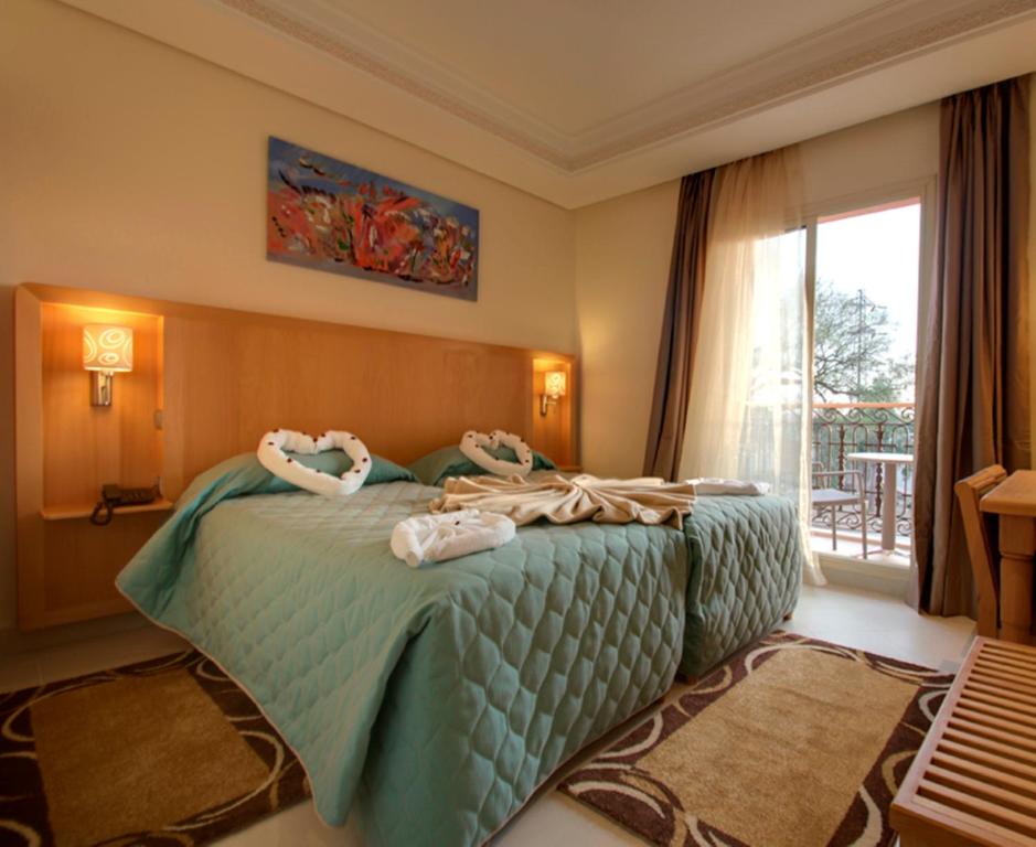 Ліжко або ліжка в номері Hotel Palais Al Bahja
