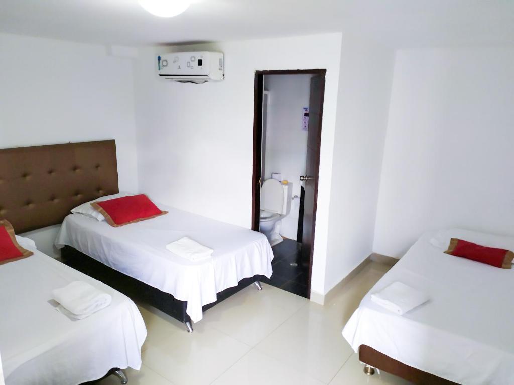 Postel nebo postele na pokoji v ubytování Hotel Plaza Colonial