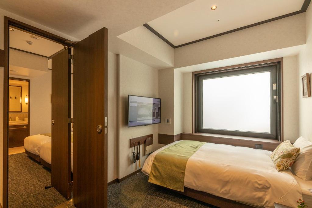 Postel nebo postele na pokoji v ubytování Hotel Aru Kyoto Sanjo Kiyamachi Do-ri