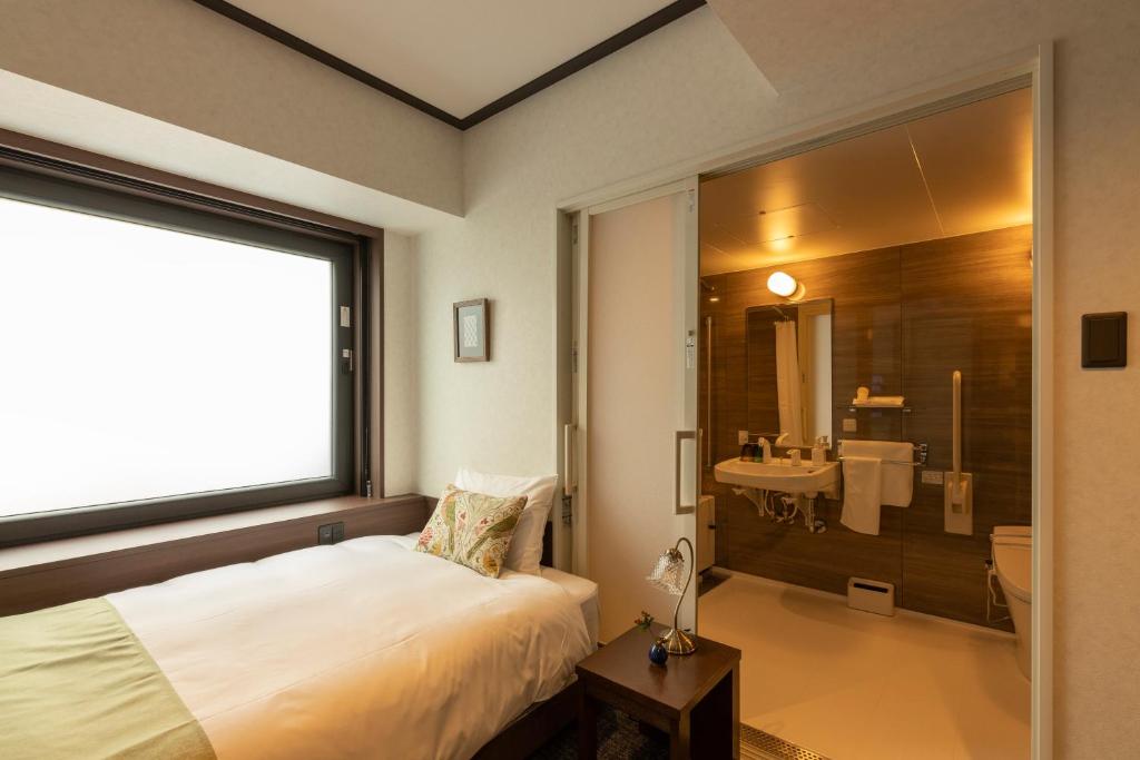 Postel nebo postele na pokoji v ubytování Hotel Aru Kyoto Sanjo Kiyamachi Do-ri