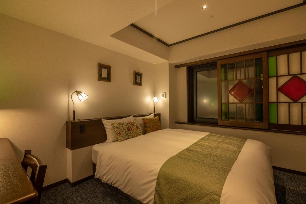 Postel nebo postele na pokoji v ubytování Hotel Aru Kyoto Sanjo Kiyamachi Do-ri