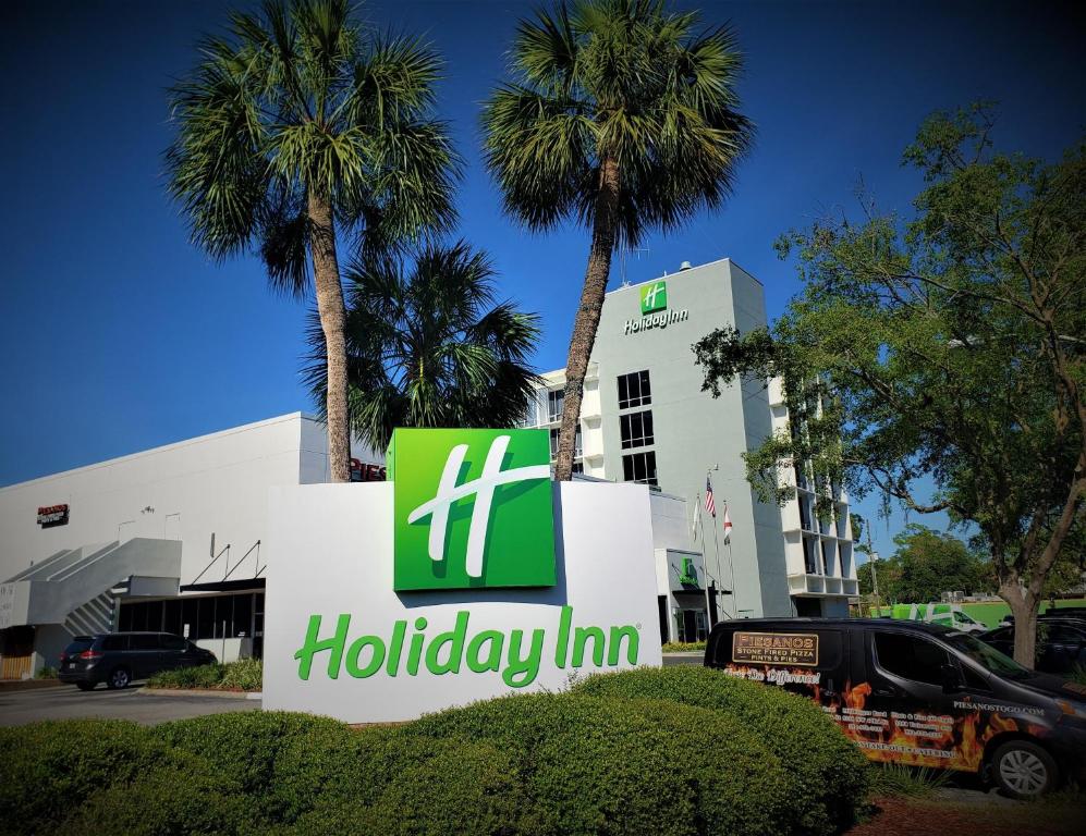 a large palm tree in front of a large building at Holiday Inn Gainesville-University Center, an IHG Hotel in Gainesville