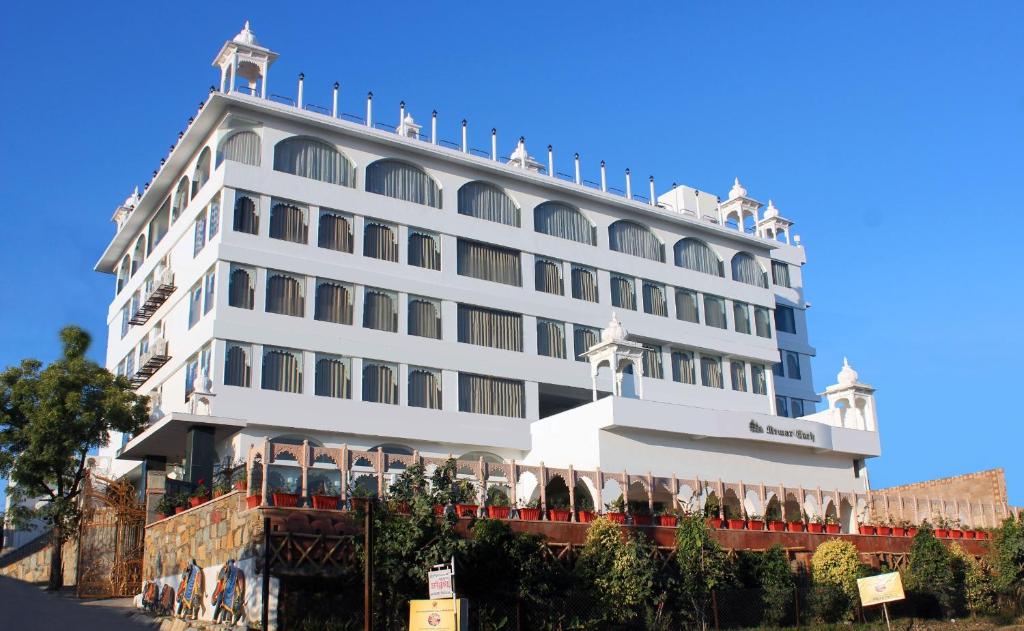 a large white building with a lot of windows at Regenta Central Mewargarh, Near Biological park in Udaipur