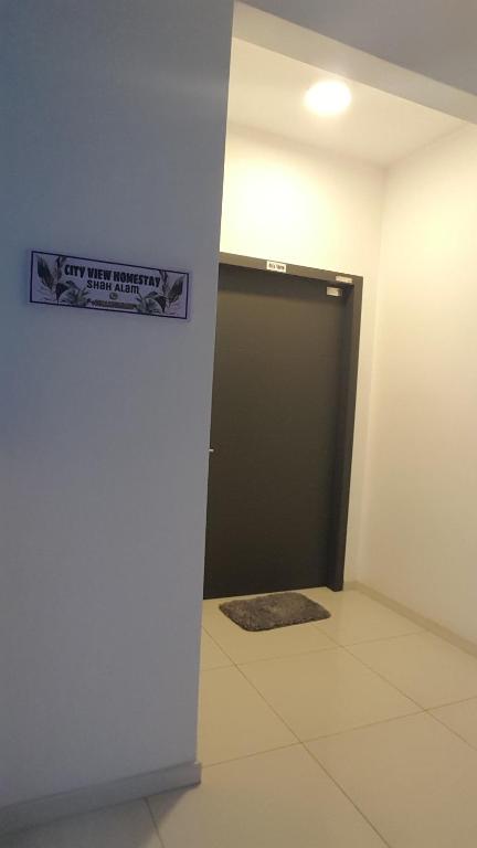 a garage door with a sign on the wall at Cityview Homestay Seksyen 13 Shah Alam, Aeon Mall, Stadium, I-City in Shah Alam