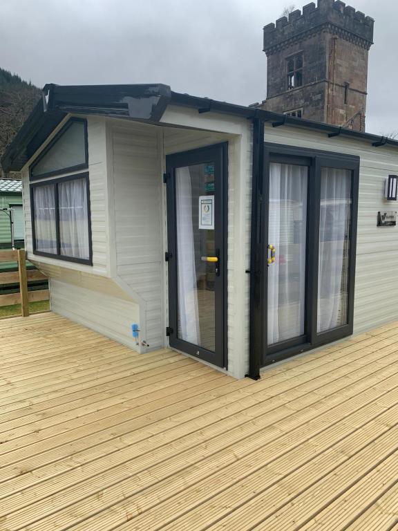 a house with a door on a deck at The Castleton in Dunoon