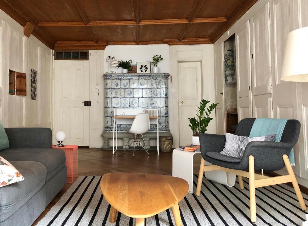 a living room with a couch and a table at Historical Flat, by Zytglogge - 1st Floor in Bern