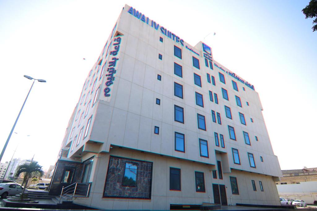 a tall white building with a sign on it at Platinum Park in Taif