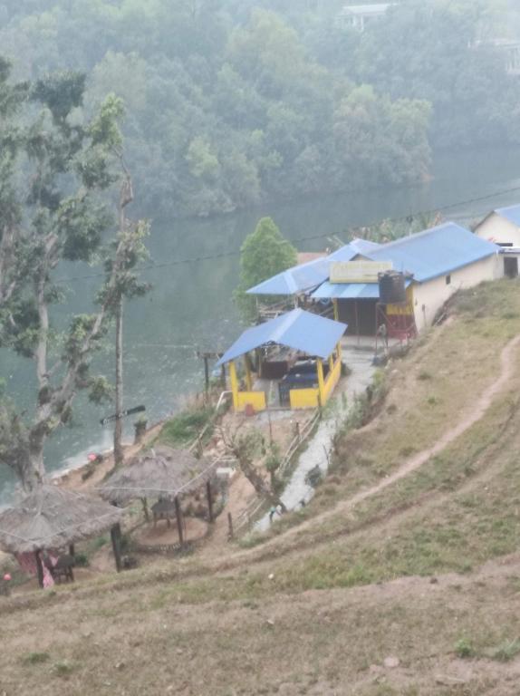 a building with blue roofs on top of a hill at The Begnas sound healing center in Deorāli