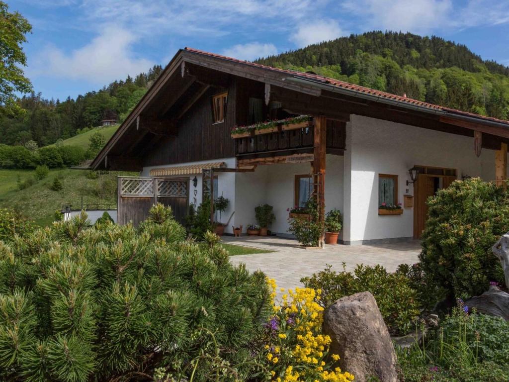 a house with a mountain in the background at Haus Christl in Berchtesgaden