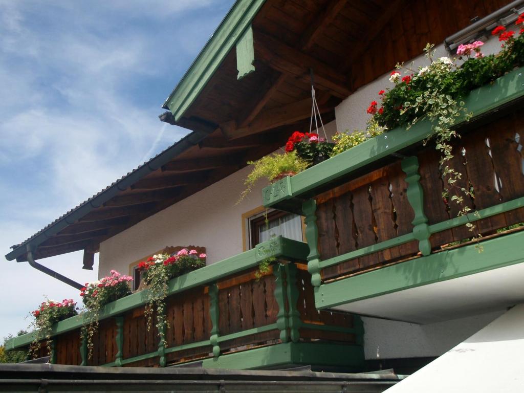 a house with flowers on the balcony at Ferienwohnungen Rabe in Prien am Chiemsee