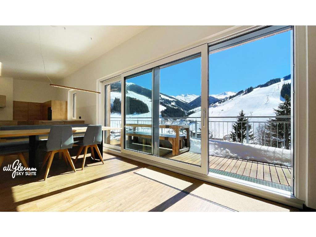 a kitchen and dining room with a view of a mountain at All.Glemm SKY SUITE in Saalbach Hinterglemm