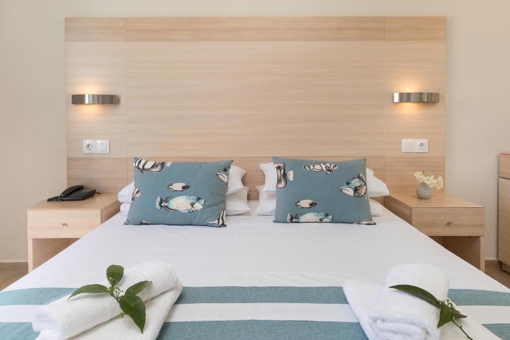 A bed or beds in a room at Iliada Beach Hotel