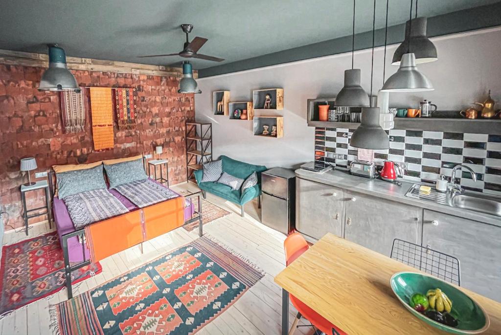 a kitchen with a room with a bed and a table at Hungry Grape Guests in Erdőbénye