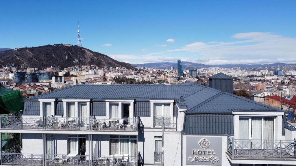 a hotel building with a view of a city at MariaLuis Hotel in Tbilisi City