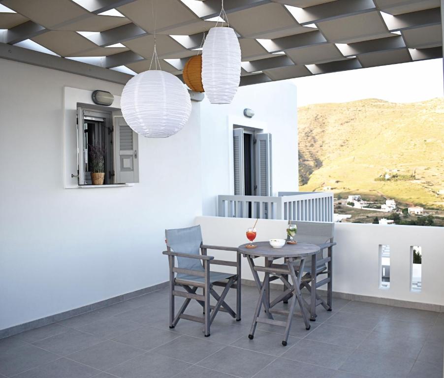 a dining room with a table and chairs at Antigoni Villas in Gavrio