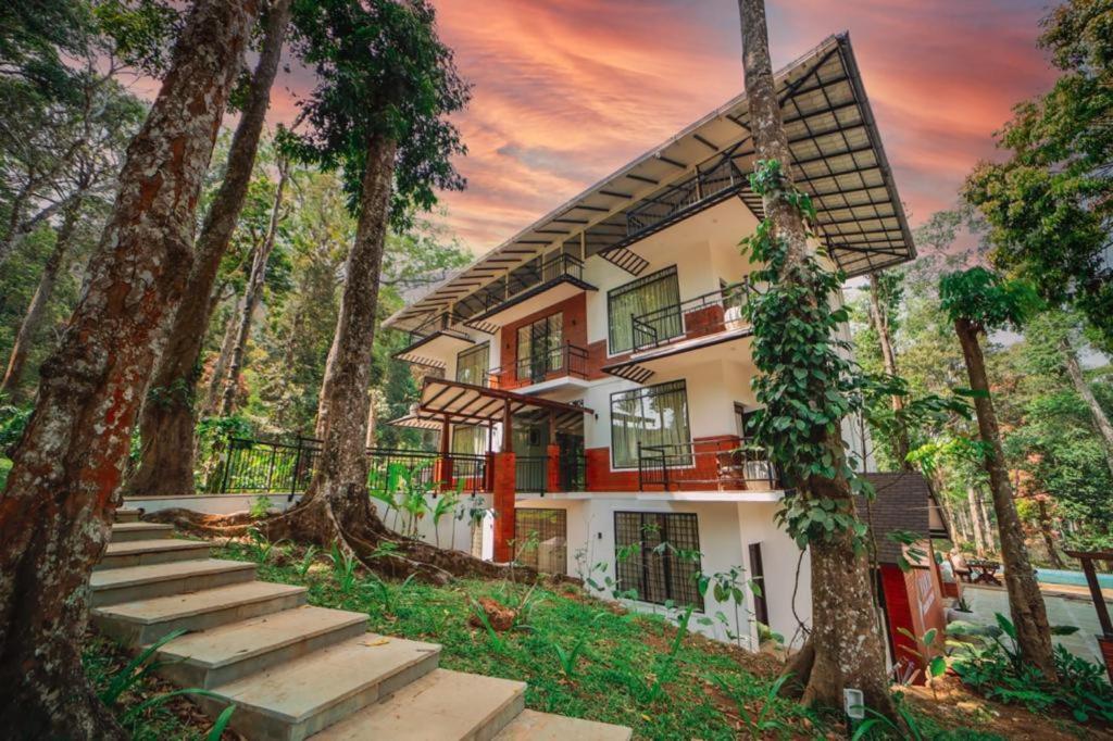 a house in the middle of a forest at VANYA by Citrine in Nelliyampathy