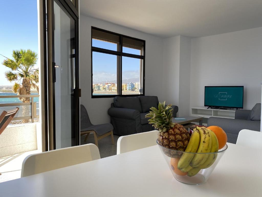 a bowl of fruit on a table in a living room at Arinaga Colors, tu casa en la playa in Arinaga