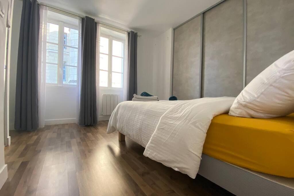 a bedroom with a large bed and a window at Maison Saint Louis in Poitiers