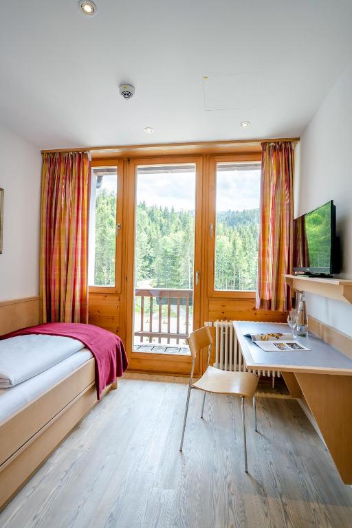 Postel nebo postele na pokoji v ubytování Berghotel Sudelfeld