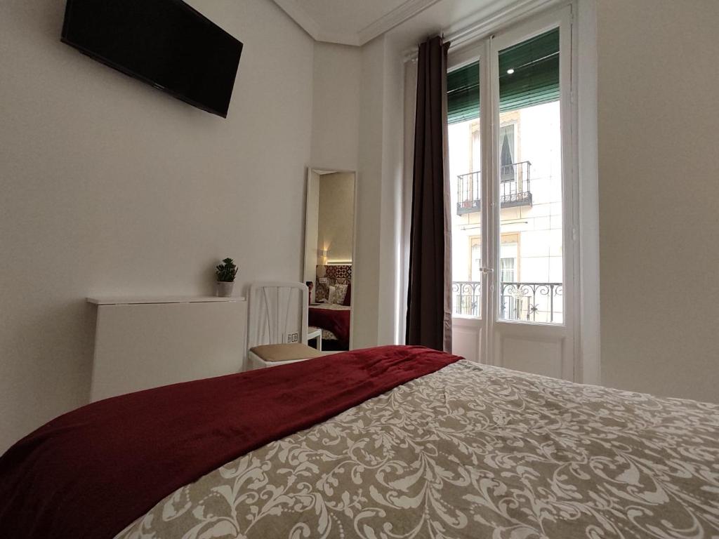 Postel nebo postele na pokoji v ubytování Hostal Alfaro