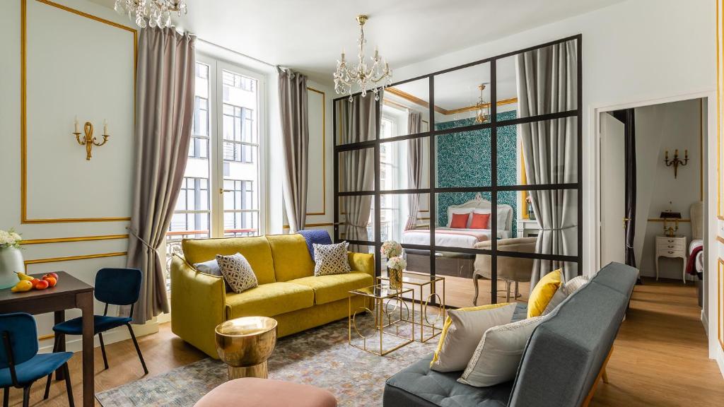 a living room with a yellow couch and a table at Luxury 2 Bedroom 2 Bathroom Apartment - Louvre in Paris