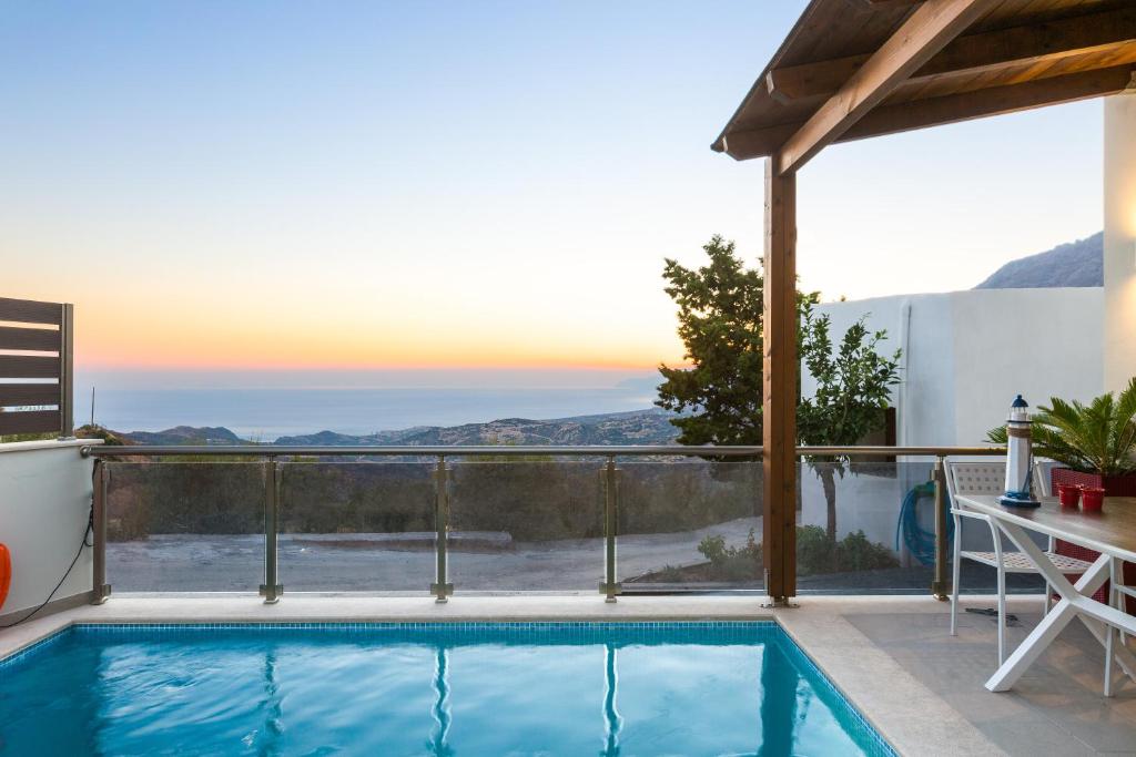 a swimming pool on the balcony of a house at Villa Saktouris in Saktoúria