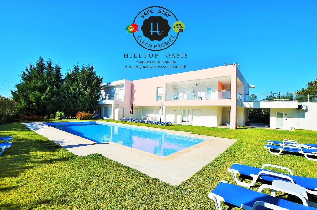 a villa with a swimming pool in front of a house at HILLTOP OASIS Lisboa Oeiras in Oeiras