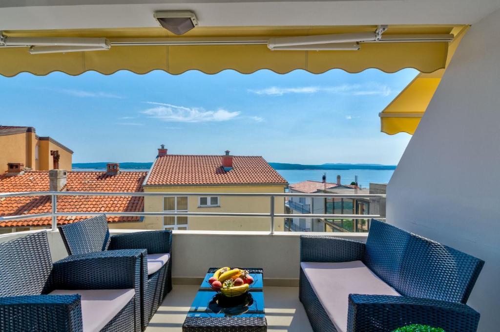 a balcony with chairs and a view of the ocean at Ilicevic Kralja Zvonimira in Crikvenica
