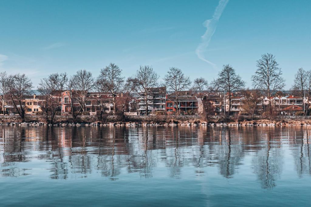 a large body of water with buildings in the background at Akti Hotel Ioannina in Ioannina