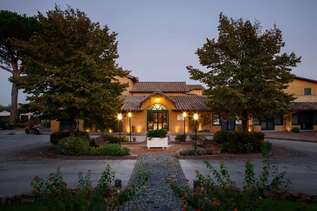 a building with a lit up facade with trees at Hotel Selva Candida in Selva Candida 