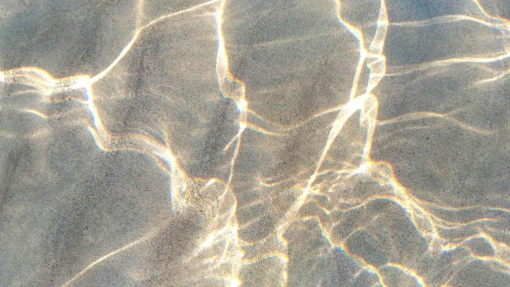 a close up of water with light reflecting on it at B&B Il Gatto Pescatore in Stintino